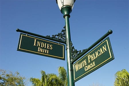 Orchid Island Getting Here Gold and Green Street Sign at Orchid Island showing the intersection of