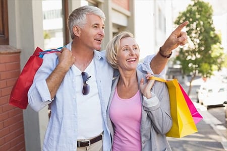 Vero Beach Shopping Older Couple carrying bags, window shopping in Vero Beach
